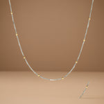 Load image into Gallery viewer, A sterling silver chain with a dual color feature, showcasing silver balls on its links with a close-up inset of the chain's texture.