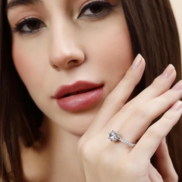 Close-up of a woman's hand wearing a diamond ring with a blurred background