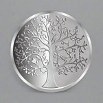 Load image into Gallery viewer, A silver coin with an intricate design depicting the 'Tree of Life'.