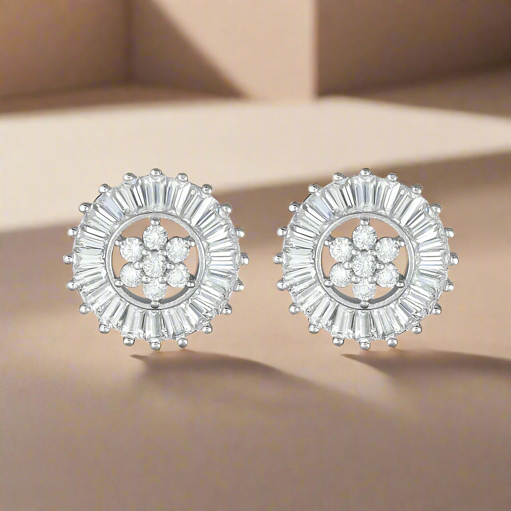 A pair of sterling silver baguette cut earrings studded with clear cubic zirconia, arranged in a circular pattern with a central point.