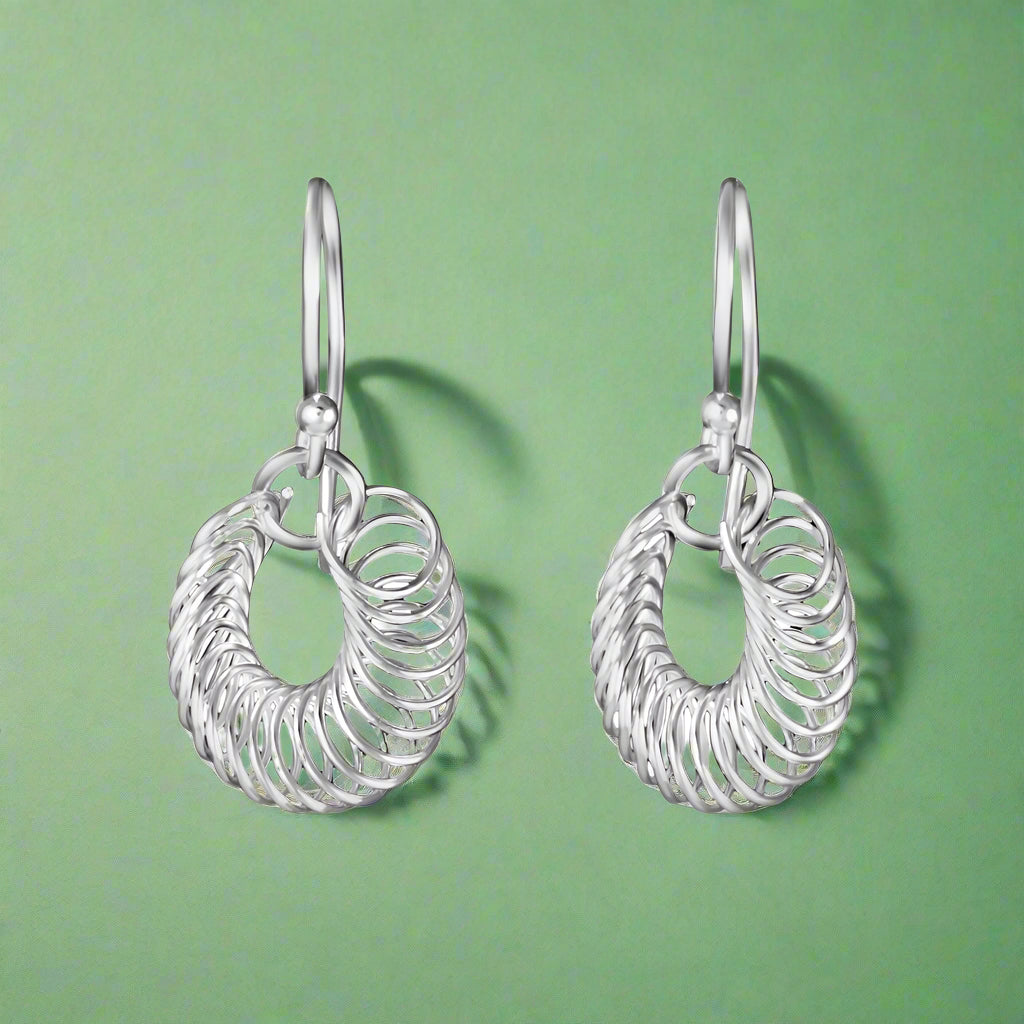 A pair of sterling silver hoop earrings with a linked chain design, displayed against a white background.