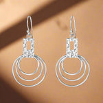 Load image into Gallery viewer, A pair of 925 sterling silver hoop earrings with a geometric design featuring multiple circles.