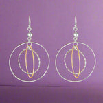 Load image into Gallery viewer, A pair of Galaxy Two Tone Link 925 Sterling Silver Earrings, featuring large silver hoops with gold accents, dangle from fish hook closures.