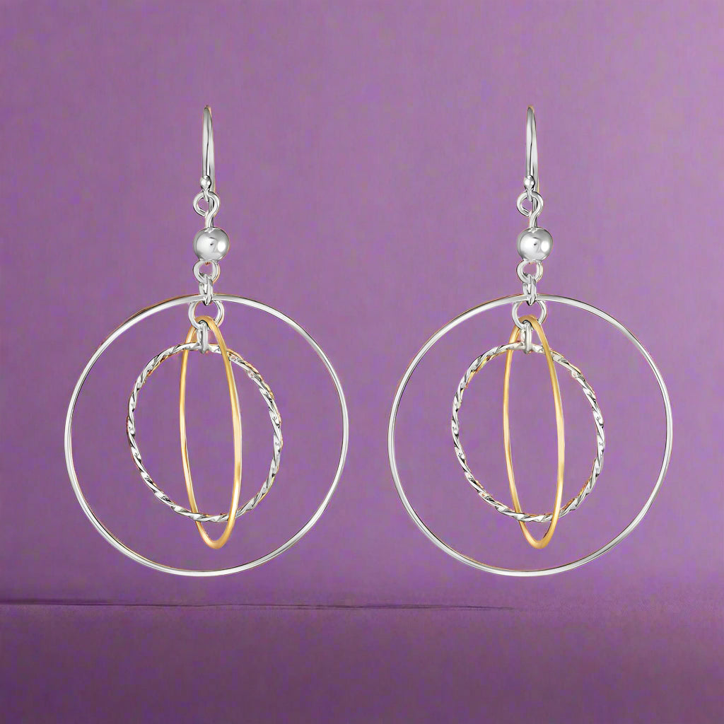A pair of Galaxy Two Tone Link 925 Sterling Silver Earrings, featuring large silver hoops with gold accents, dangle from fish hook closures.