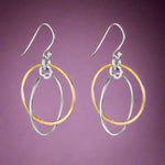 Load image into Gallery viewer, A pair of two-tone round 925 sterling silver hook earrings with one earring featuring gold-colored loops and silver-colored loops on the other, displayed against a white background.
