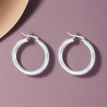 Load image into Gallery viewer, A pair of Mukti 925 sterling silver hoop earrings with a two-tone design, displayed against a white background.