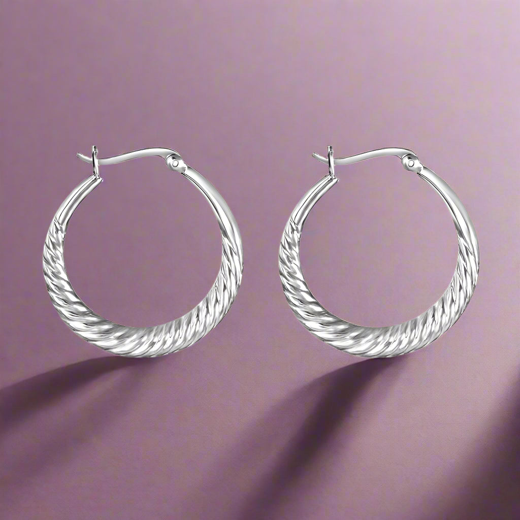 A pair of sterling silver hoop earrings with a twisted hoop design, displayed against a white background.
