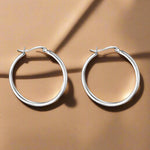 Load image into Gallery viewer, A pair of round, 925 sterling silver hoop earrings