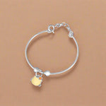 Load image into Gallery viewer, Silver baby bracelet with a yellow charm on a white background