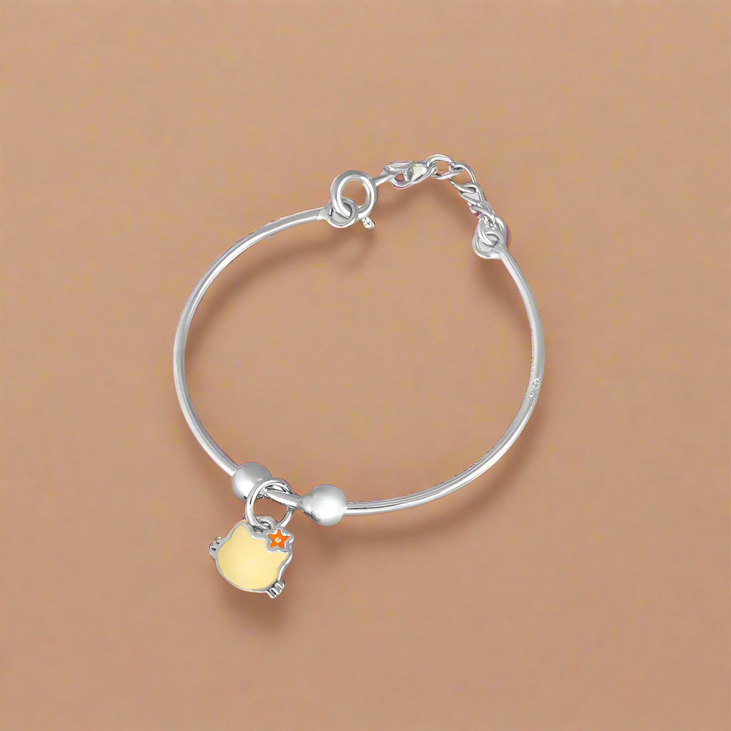 Silver baby bracelet with a yellow charm on a white background