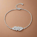 Load image into Gallery viewer, A sterling silver bracelet with a floral pattern of cubic zirconia stones, featuring an adjustable clasp.