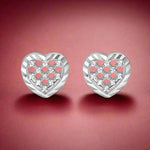 Load image into Gallery viewer, A pair of plain silver stud earrings with a heart pattern and inset with small clear crystals.