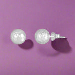 Load image into Gallery viewer, A pair of sterling silver stud earrings with a dazzling effect, featuring a smooth and polished finish.