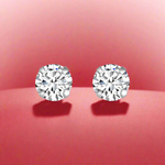 Load image into Gallery viewer, A pair of solitaire round 925 sterling silver stud earrings with a shimmering appearance.
