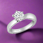 Load image into Gallery viewer, A Smitri 925 Sterling Silver Solitaire Ring with a clear, AAA cubic zirconia center stone, surrounded by smaller clear stones set in a white gold-colored band.