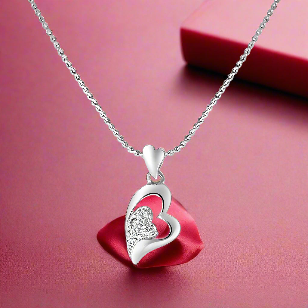 A 925 silver pendant in the shape of a heart with a chain, adorned with cubic zirconia stones.