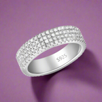 Load image into Gallery viewer, A sterling silver ring with a sparkling eternity design studded with cubic zirconias, with the ring size 'S' inscribed on the band.