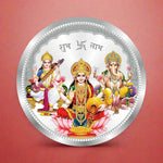 Load image into Gallery viewer, A silver coin with a circular design featuring Laxmi, Ganesh, and Saraswati, three Hindu deities, seated on a lotus with a floral background.