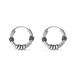 Load image into Gallery viewer, Pair of silver hoop earrings on a white background
