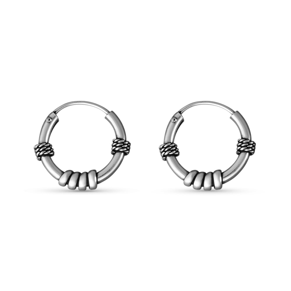Pair of silver hoop earrings on a white background