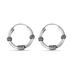 Load image into Gallery viewer, Pair of silver hoop earrings with woven design on a white background
