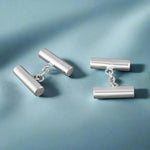 Load image into Gallery viewer, Pair of silver cylindrical cufflinks on a white background
