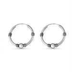 Load image into Gallery viewer, Pair of silver hoop earrings with bead accents on a white background
