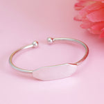 Load image into Gallery viewer, Silver bracelet with a pink stone on a pink background
