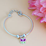 Load image into Gallery viewer, Silver bracelet with a butterfly charm on a pink floral background
