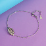 Load image into Gallery viewer, Silver bracelet with a decorative clasp on a purple and blue background
