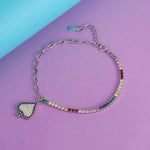 Load image into Gallery viewer, Bracelet with heart charm and multicolored beads on a purple and blue background
