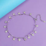 Load image into Gallery viewer, Silver star necklace on a purple and blue background
