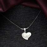 Load image into Gallery viewer, Silver heart-shaped pendant with &#39;LOVE&#39; engraving on a dark textured surface

