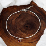Load image into Gallery viewer, Silver beaded anklet with a red heart charm on a purple and blue background
