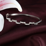 Load image into Gallery viewer, Silver bracelet with diamond accents on a dark fabric background
