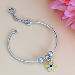 Load image into Gallery viewer, Silver bracelet with a colorful flower charm on a pink floral background
