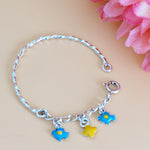 Load image into Gallery viewer, Bracelet with colorful charms on a beige background with pink flowers
