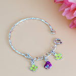 Load image into Gallery viewer, Silver bracelet with colorful charms on a pink floral background
