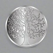 A silver coin with an intricate design depicting the 'Tree of Life'.