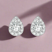A pair of sterling silver earrings with a central pear-shaped stone surrounded by clear cubic zirconia accents.