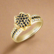 A 925 sterling silver ring with a floral design and black and white cubic zirconia accents.