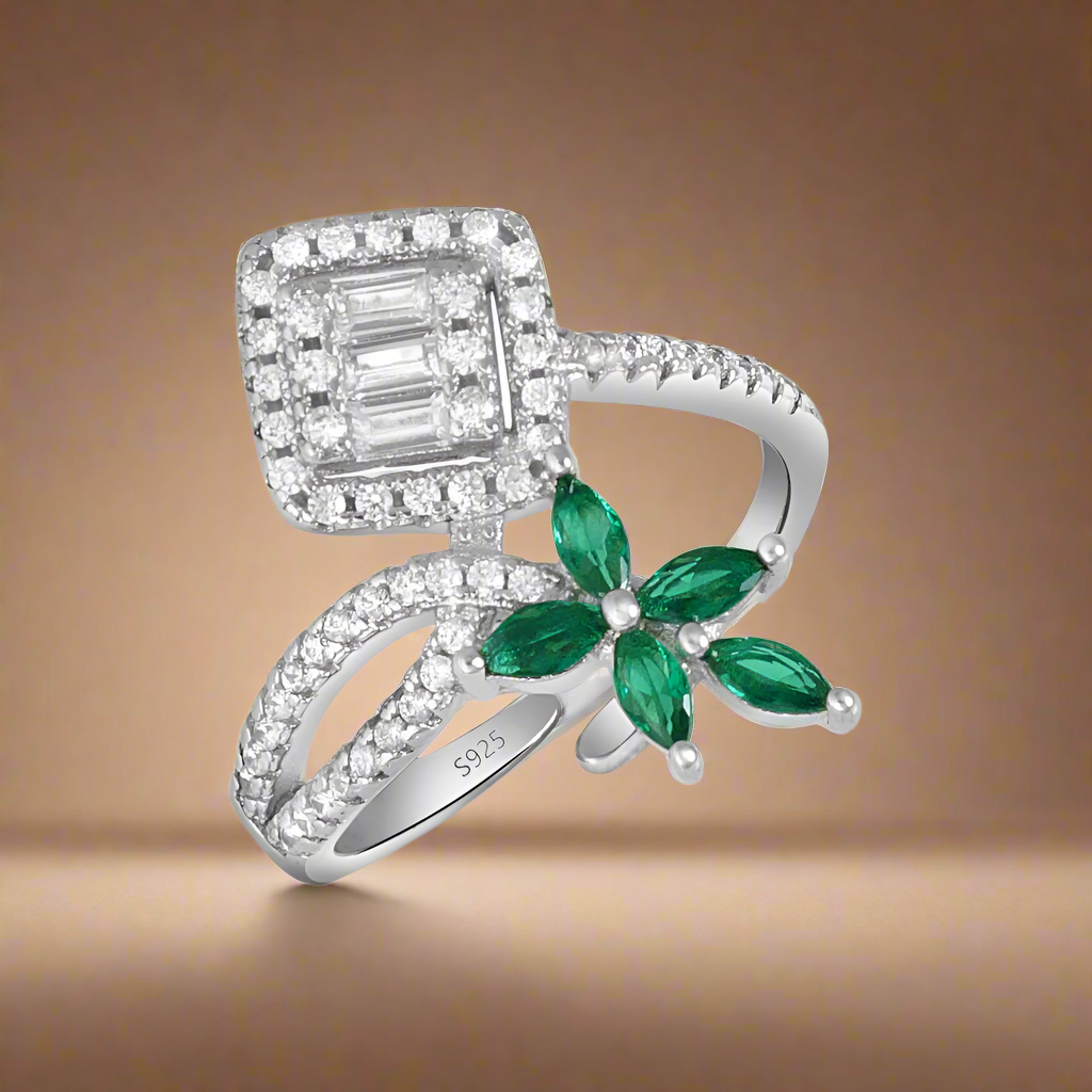 A 925 sterling silver ring with a dual element design, featuring a green butterfly-shaped stone and clear cubic zirconia stones set in a polished, silver finish.