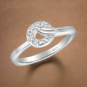 A 925 sterling silver ring with a central cubic zirconia design surrounded by smaller clear crystals set in a silver band.