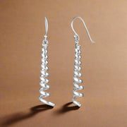 A pair of 925 sterling silver hoop earrings with a twist design, suitable for daily wear and special occasions.