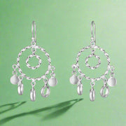 A pair of 925 sterling silver hoop earrings with small dangling round silver charms, showcasing a shiny, reflective silver finish.