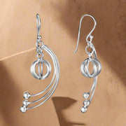 A pair of sterling silver hoop earrings with dangling feathered links and pearl accents.