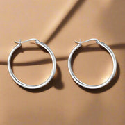 A pair of round, 925 sterling silver hoop earrings