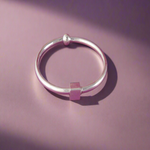 Load image into Gallery viewer, Silver bracelet on a pink background

