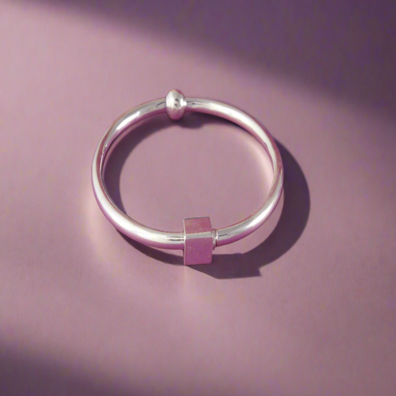 Silver bracelet on a pink background