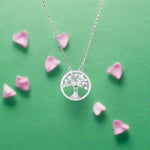 Load image into Gallery viewer, Silver tree of life necklace on a purple background
